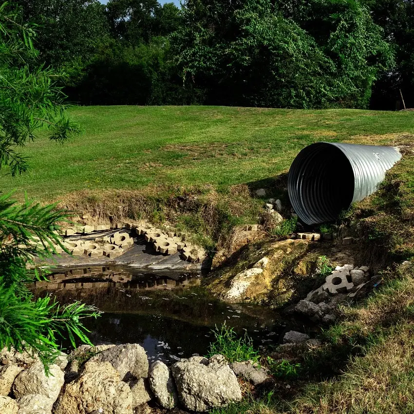 A pipe draining water into a river